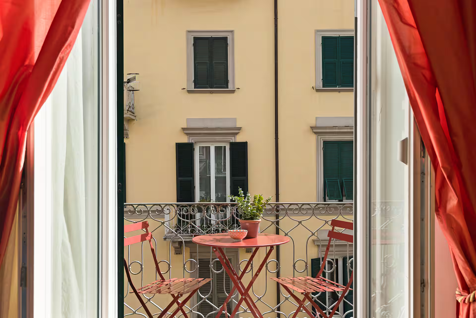 Balcony with bistro table overlooking Italian street